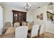 Traditional dining area boasts an elegant chandelier and custom wooden hutch at 18107 Sugar Brooke Dr, Tampa, FL 33647