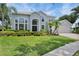 Beautiful two-story home boasts manicured lawn, lush landscaping and a large front yard at 18107 Sugar Brooke Dr, Tampa, FL 33647