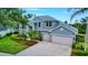 Beautiful two-story home features a two-car garage, manicured landscaping, and a concrete driveway at 18107 Sugar Brooke Dr, Tampa, FL 33647