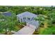 The exterior of this two-story home features a two-car garage and professionally landscaped yard at 18107 Sugar Brooke Dr, Tampa, FL 33647