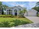 Beautiful two-story home boasts manicured lawn, lush landscaping and a large front yard at 18107 Sugar Brooke Dr, Tampa, FL 33647