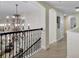 Second floor hallway with decorative lighting and beautiful railings at 18107 Sugar Brooke Dr, Tampa, FL 33647