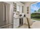 Close up of eat in kitchen featuring a stainless steel refrigerator and custom cabinets with a beverage fridge at 18107 Sugar Brooke Dr, Tampa, FL 33647