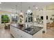 Open concept kitchen with white cabinets, granite countertops, eat in dining area, and view of the living room at 18107 Sugar Brooke Dr, Tampa, FL 33647