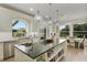 Bright kitchen with stainless steel appliances, large island, granite countertops, and open shelving for storage at 18107 Sugar Brooke Dr, Tampa, FL 33647