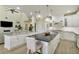 Open-concept kitchen with granite counters, stainless appliances, and a center island that flows into the living area at 18107 Sugar Brooke Dr, Tampa, FL 33647