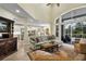 Expansive living room boasts high ceilings, lots of natural light, open access to kitchen and views of the backyard pool at 18107 Sugar Brooke Dr, Tampa, FL 33647