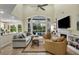 Open living room with high ceilings, natural light, backyard pool views, and a gas fireplace at 18107 Sugar Brooke Dr, Tampa, FL 33647
