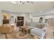 Bright living room featuring an open floor plan leading to the kitchen with wood floors and neutral tones at 18107 Sugar Brooke Dr, Tampa, FL 33647
