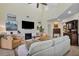 Spacious living room featuring high ceilings, large windows, gas fireplace and custom built-in shelving at 18107 Sugar Brooke Dr, Tampa, FL 33647