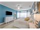 Main bedroom with bright blue walls, large windows and a comfortable sitting area at 18107 Sugar Brooke Dr, Tampa, FL 33647