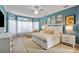 Spacious primary bedroom with sitting area and large windows offering lots of natural light at 18107 Sugar Brooke Dr, Tampa, FL 33647