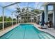 A sparkling pool with jacuzzi with a screened enclosure and lush backyard views at 18107 Sugar Brooke Dr, Tampa, FL 33647