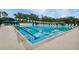 An outdoor lap pool with lane markers, lounge chairs, and pennant flags ready for a swim at 18107 Sugar Brooke Dr, Tampa, FL 33647