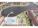 Aerial view showcasing community amenities including a pool, dock, shuffleboard, and waterfront access at 19029 Us Highway 19 N # 31F, Clearwater, FL 33764