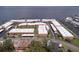 Aerial view of a waterfront community with well-maintained buildings, mature landscaping, and convenient parking areas at 19029 Us Highway 19 N # 31F, Clearwater, FL 33764