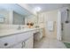 Bright bathroom with a dual sink vanity, large mirror, and walk-in shower at 19029 Us Highway 19 N # 31F, Clearwater, FL 33764