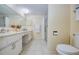 Bathroom featuring double sinks, large mirror, updated fixtures, and a walk-in shower at 19029 Us Highway 19 N # 31F, Clearwater, FL 33764