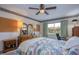 Inviting bedroom with a ceiling fan, decorative wallpaper border, and a well-lit study area at 19029 Us Highway 19 N # 31F, Clearwater, FL 33764
