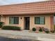 Charming condo unit featuring a red tile roof, neutral stucco, and neatly trimmed landscaping at 19029 Us Highway 19 N # 31F, Clearwater, FL 33764