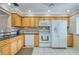 Classic kitchen design features wood cabinetry, granite countertops, and white appliances at 19029 Us Highway 19 N # 31F, Clearwater, FL 33764