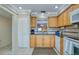 Bright eat-in kitchen with wood cabinets, granite countertops, and tile backsplash at 19029 Us Highway 19 N # 31F, Clearwater, FL 33764