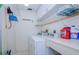 Practical laundry room with a washer, dryer, shelving and ample storage space at 19029 Us Highway 19 N # 31F, Clearwater, FL 33764
