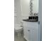 Bathroom featuring granite countertops, a decorative mirror, and a modern white vanity at 2075 Plateau Rd, Clearwater, FL 33755