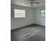 This bedroom features modern flooring, a ceiling fan, and dual windows for ample light at 2075 Plateau Rd, Clearwater, FL 33755