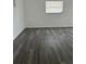 Bright bedroom featuring modern gray flooring and a window offering natural light at 2075 Plateau Rd, Clearwater, FL 33755