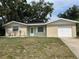 Charming single-story home with a well-maintained lawn and attached garage, presenting an inviting curb appeal at 2075 Plateau Rd, Clearwater, FL 33755