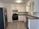 Well-lit kitchen featuring modern appliances, ample cabinetry, and sleek countertops, perfect for culinary enthusiasts at 2075 Plateau Rd, Clearwater, FL 33755