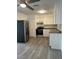 Bright kitchen with stainless steel appliances, sleek countertops, and new flooring, combining style and functionality at 2075 Plateau Rd, Clearwater, FL 33755