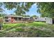 Expansive backyard featuring a deck, picnic table, and well-maintained lawn, perfect for entertaining and outdoor activities at 2122 W Ferris Ave, Tampa, FL 33603