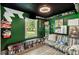 Green bedroom with dark ceiling, a window, a seating area, and shelves at 2122 W Ferris Ave, Tampa, FL 33603