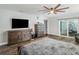 Spacious main bedroom featuring wood floors, modern furnishings, and a sliding glass door to the patio at 2122 W Ferris Ave, Tampa, FL 33603