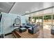 Covered back patio featuring a hanging chair, outdoor furniture, and screened-in lanai views at 2122 W Ferris Ave, Tampa, FL 33603