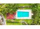 Aerial shot of a community pool with lounge chairs, surrounding landscaping, and a nearby building at 2597 Countryside Blvd # 206, Clearwater, FL 33761
