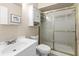 Bright bathroom with white vanity, frosted glass shower and updated fixtures at 2597 Countryside Blvd # 206, Clearwater, FL 33761
