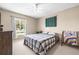 Comfortable bedroom with a ceiling fan, window with tree views, and bright neutral paint at 2597 Countryside Blvd # 206, Clearwater, FL 33761