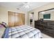 Comfortable bedroom with a closet, dresser, and mirror to ensure you're always looking your best at 2597 Countryside Blvd # 206, Clearwater, FL 33761