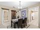 Dining room featuring modern table, chairs, and decor with access to kitchen and living area at 2597 Countryside Blvd # 206, Clearwater, FL 33761