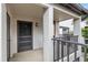 A private entrance featuring a screened door, overhead lighting, and textured stucco walls at 2597 Countryside Blvd # 206, Clearwater, FL 33761