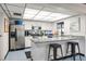 White-toned community kitchen with modern appliances and granite counters at 2597 Countryside Blvd # 206, Clearwater, FL 33761