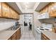 Open-concept kitchen boasts stainless steel appliances, tile flooring, and seamless access to the living space at 2597 Countryside Blvd # 206, Clearwater, FL 33761
