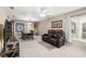 Spacious living room with cozy seating and a view of the dining area at 2597 Countryside Blvd # 206, Clearwater, FL 33761