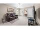 Cozy living room with a plush recliner, bright windows and neutral color palette at 2597 Countryside Blvd # 206, Clearwater, FL 33761
