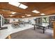 Bright community room featuring tables, chairs, ping pong, and bookshelves at 2597 Countryside Blvd # 206, Clearwater, FL 33761