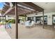 Outdoor patio area with shaded seating and a pergola at 2597 Countryside Blvd # 206, Clearwater, FL 33761