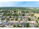 This aerial view showcases the home situated in a residential area featuring community green spaces and mature trees at 2816 Manor Hill Dr, Brandon, FL 33511